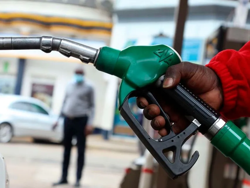 Close-up of a hand holding a fuel pump nozzle