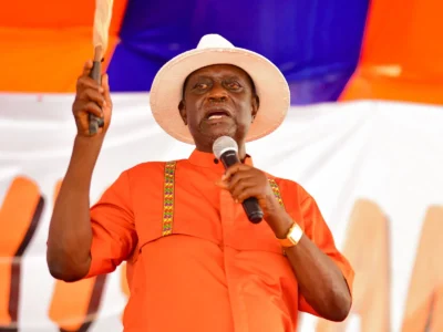 Supporter in orange speaking at a rally