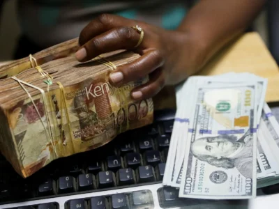 Bundle of Kenyan shilling notes next to US dollar bills